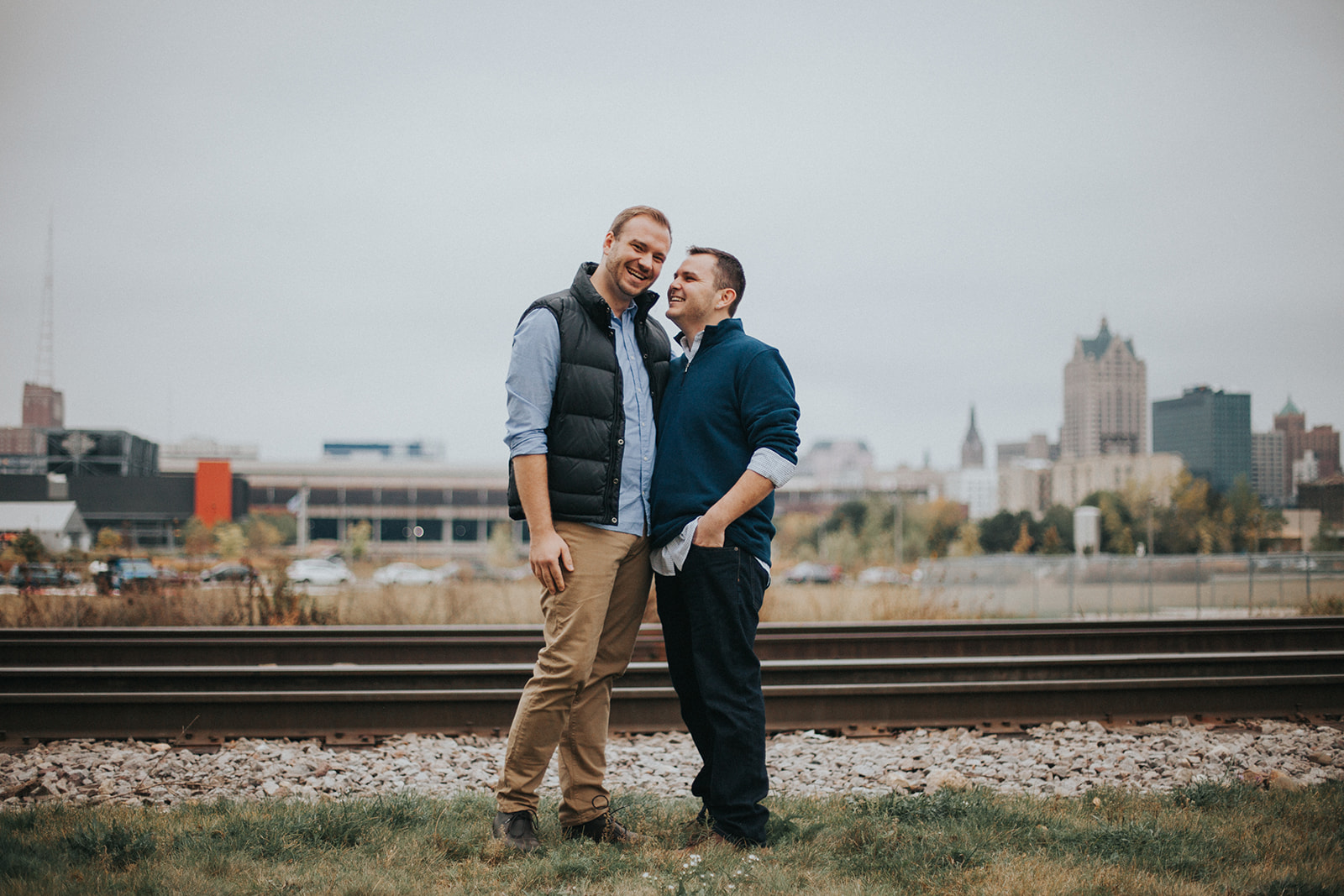 same sex couple poses in milwaukee during their engagement session