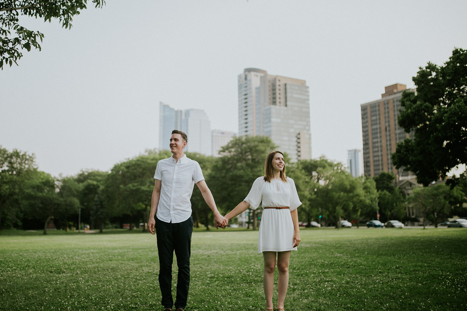 couple holds hands during their engagement session in milwaukee