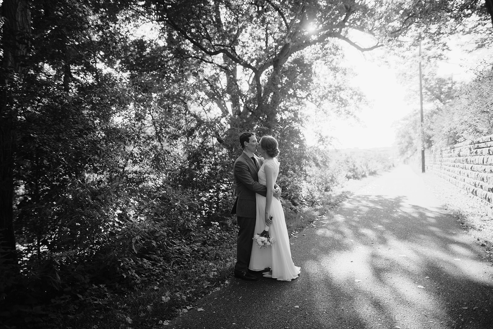 couple kisses as trees light up around them on their wedding day in eau claire wisconsin at the oxbow hotel