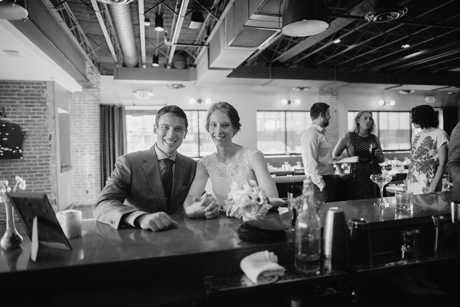 couple smiles inside of the oxbow hotel in eau claire