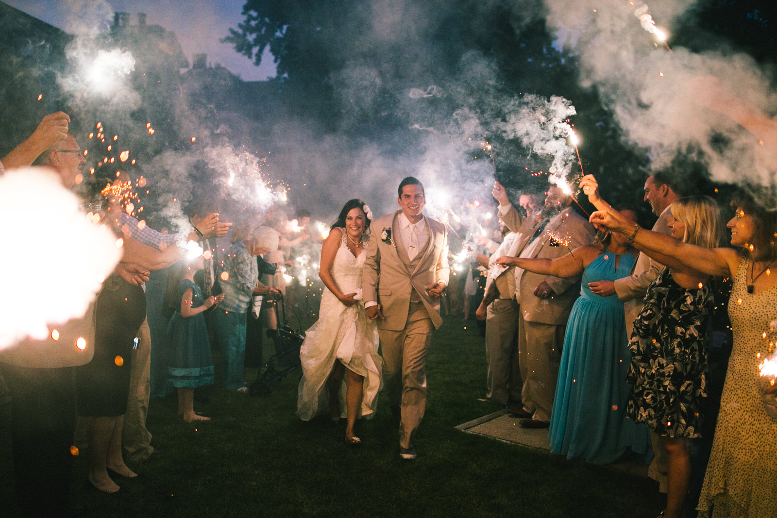 couple runs through sparklers on their wedding day at the elks lodge in madison, wisconsin