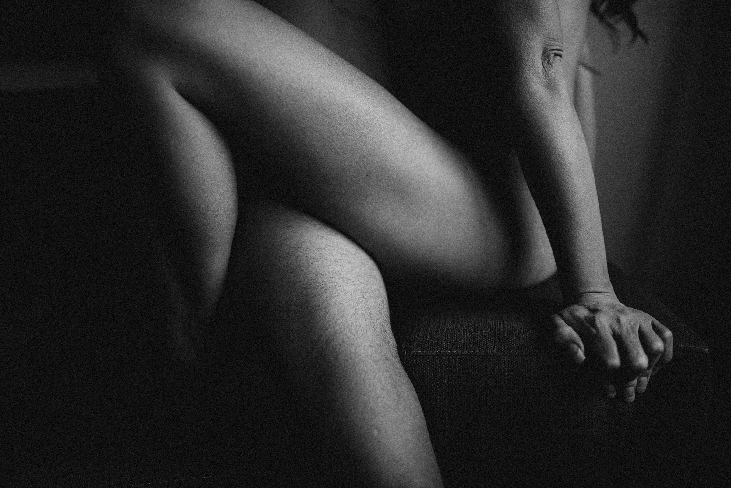black and white photo of two bodies up close during their boudoir session