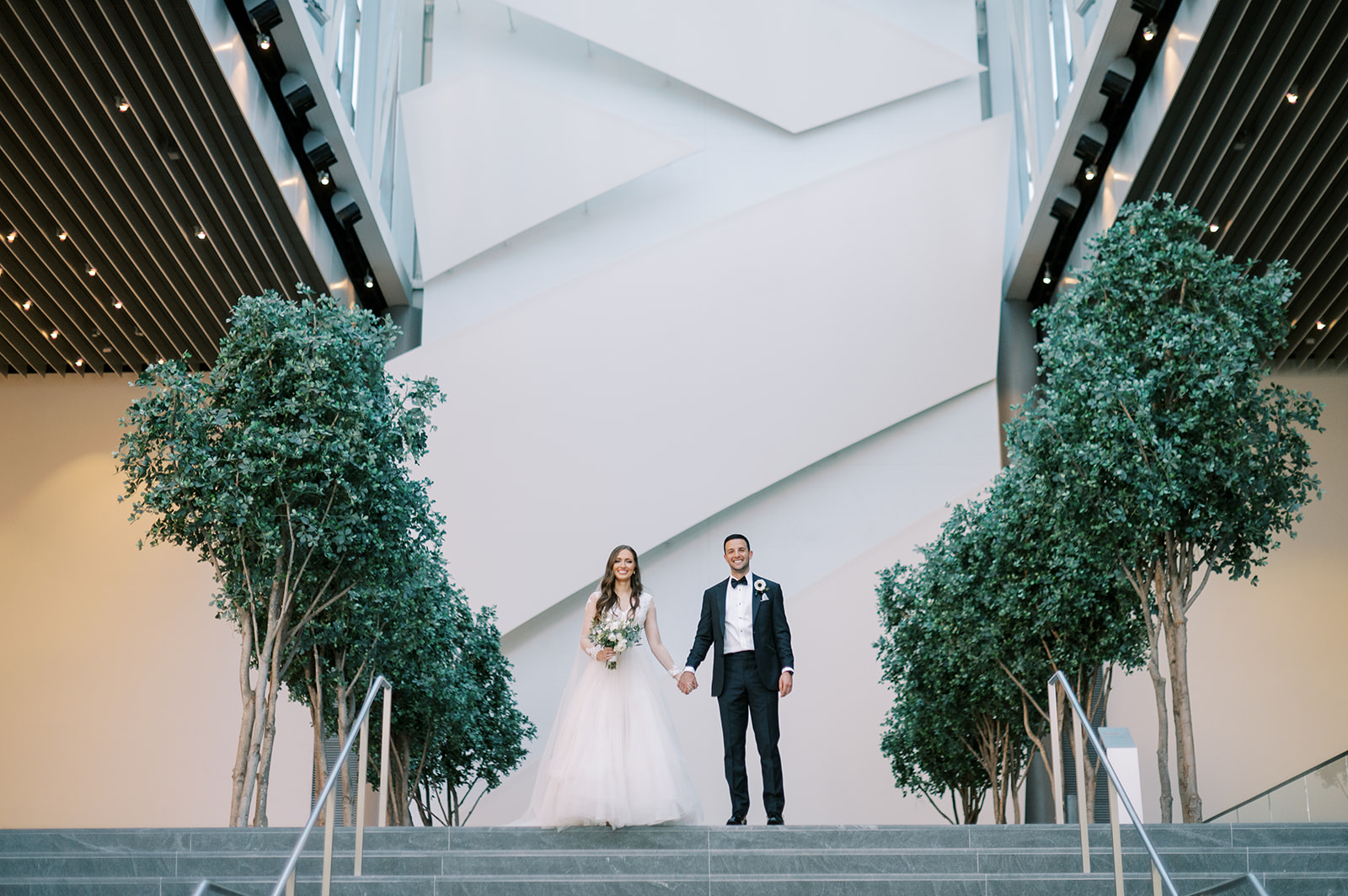 bride and groom on stairs at founders hall wedding in charlotte