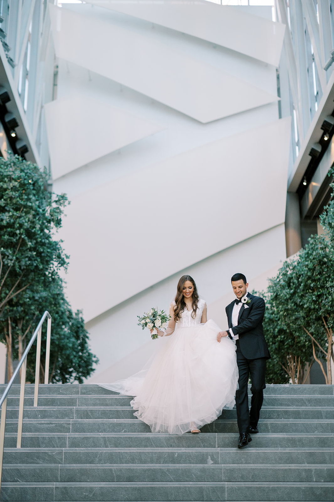 bride and groom on stairs at founders hall wedding in charlotte