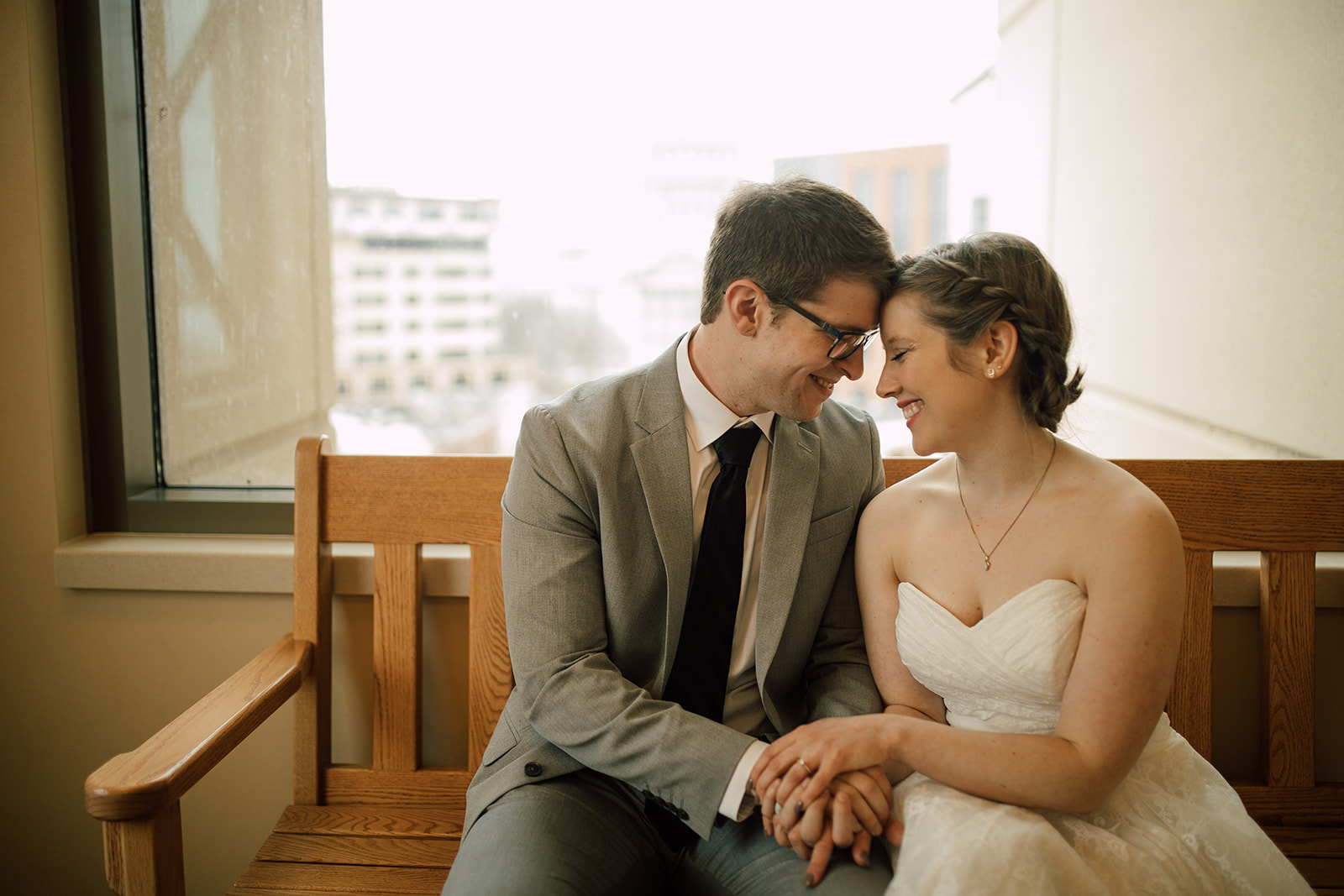 couple embraces before their intimate courthouse elopement in madison wisconsin