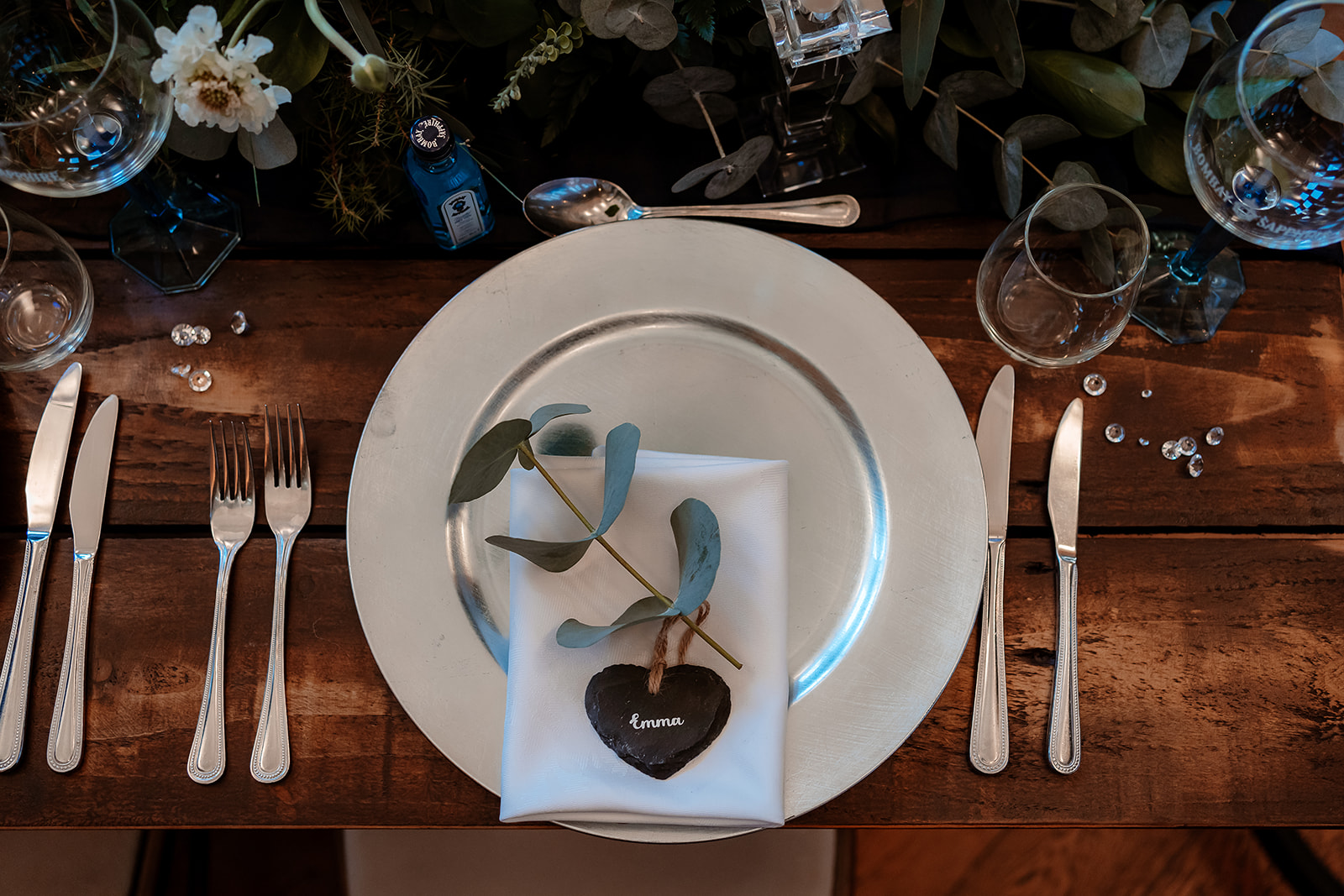 Wedding table place setting with eucalyptus leaves at the Bombay Sapphire gin distillery.