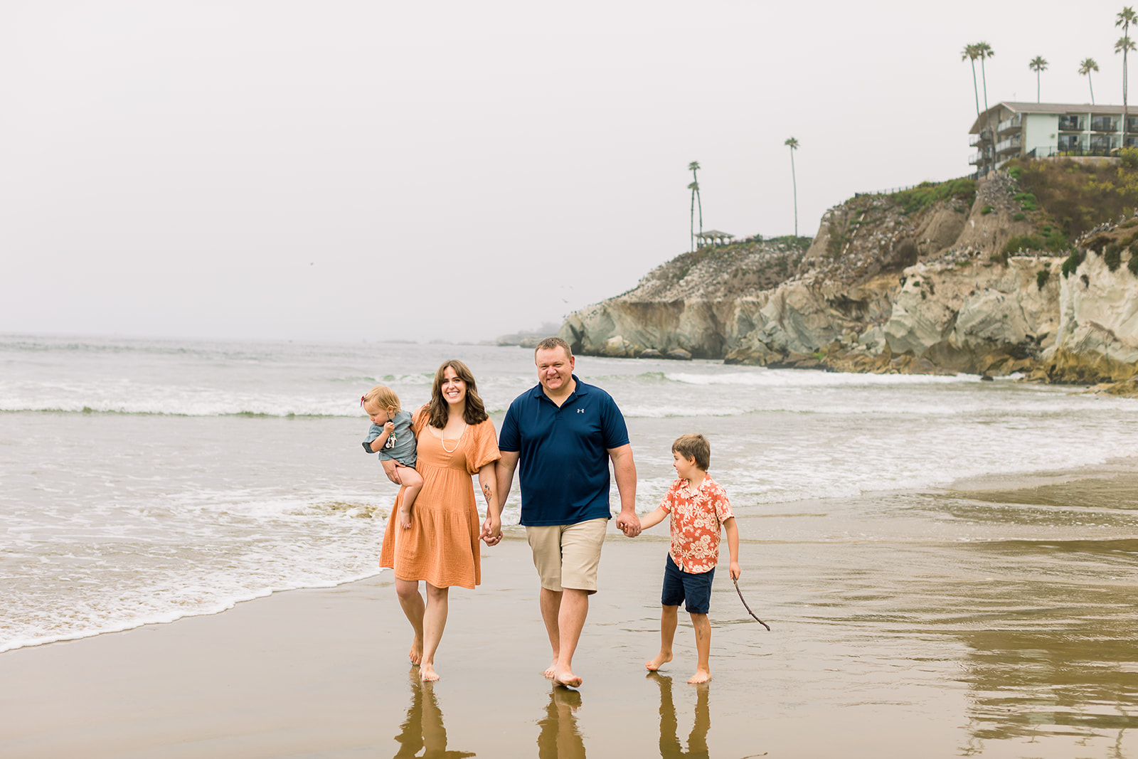 A heartwarming family moment captured against the stunning backdrop of Pismo Beach's pristine shoreline. 