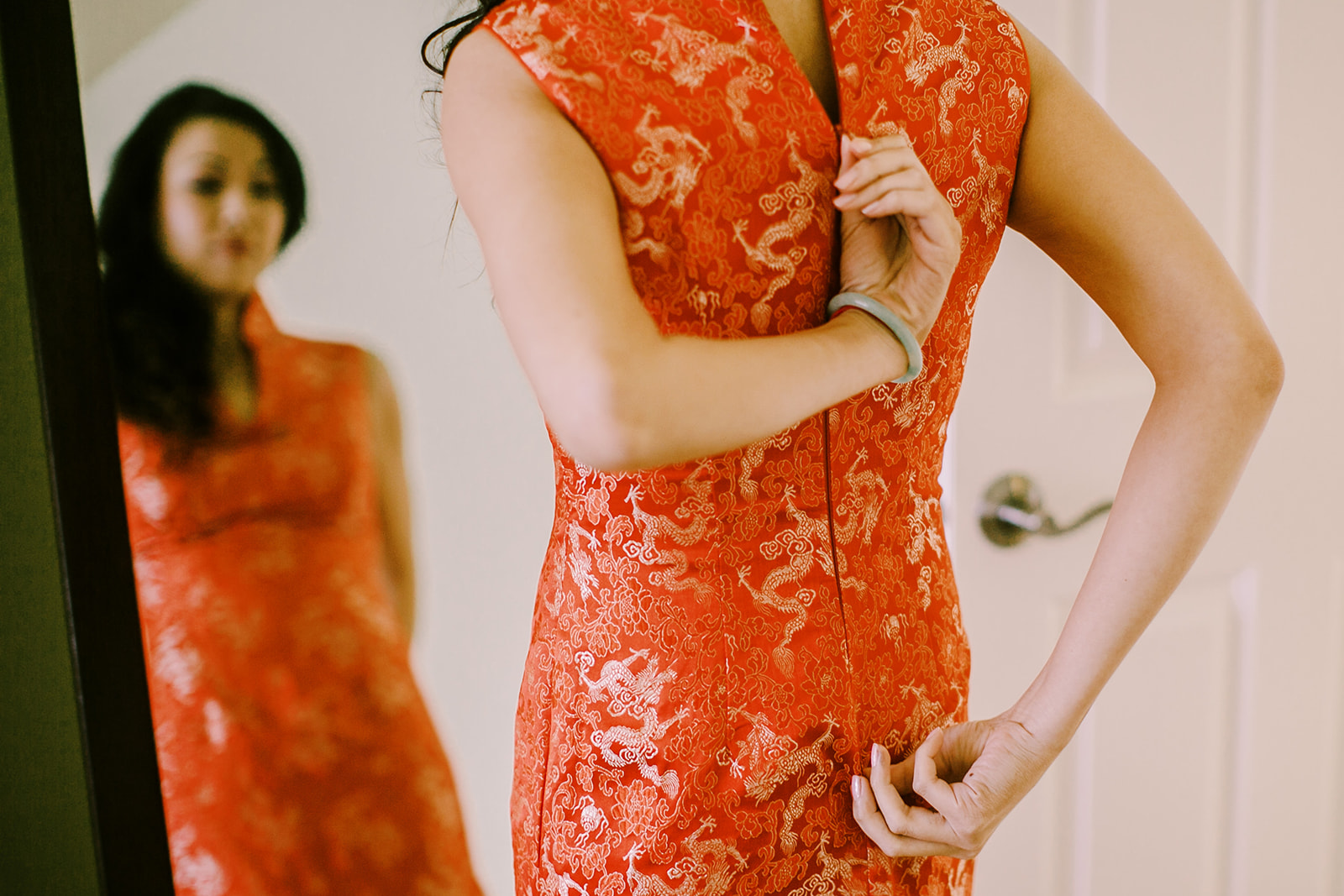 Bride Carolyn putting on her Chinese qipao for tea ceremony