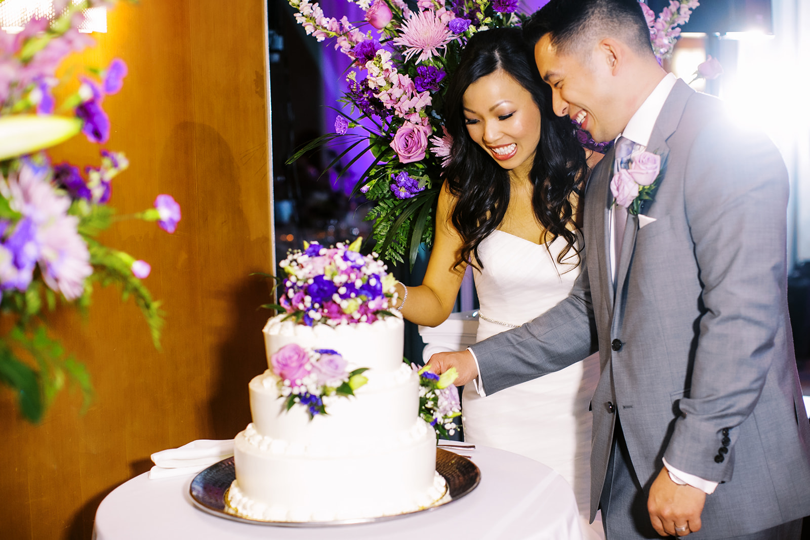 Couple cutting wedding cake at Bell Harbor Conference Wedding