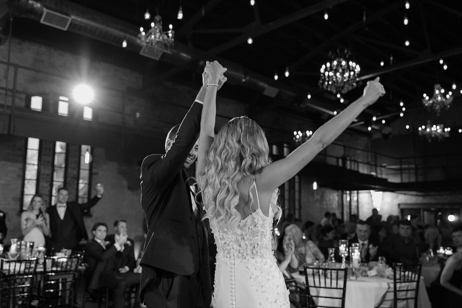 Bride and groom cheer during their first dance. 