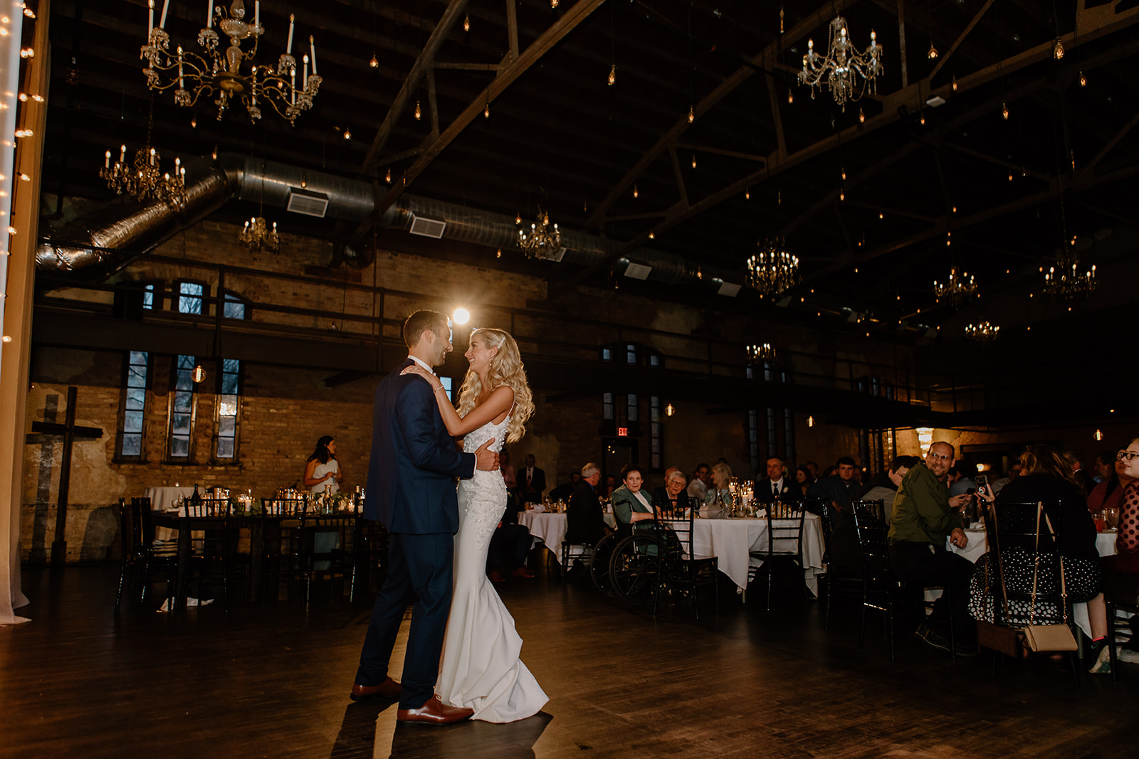 Bride and groom share their first dance on the dance floor. 