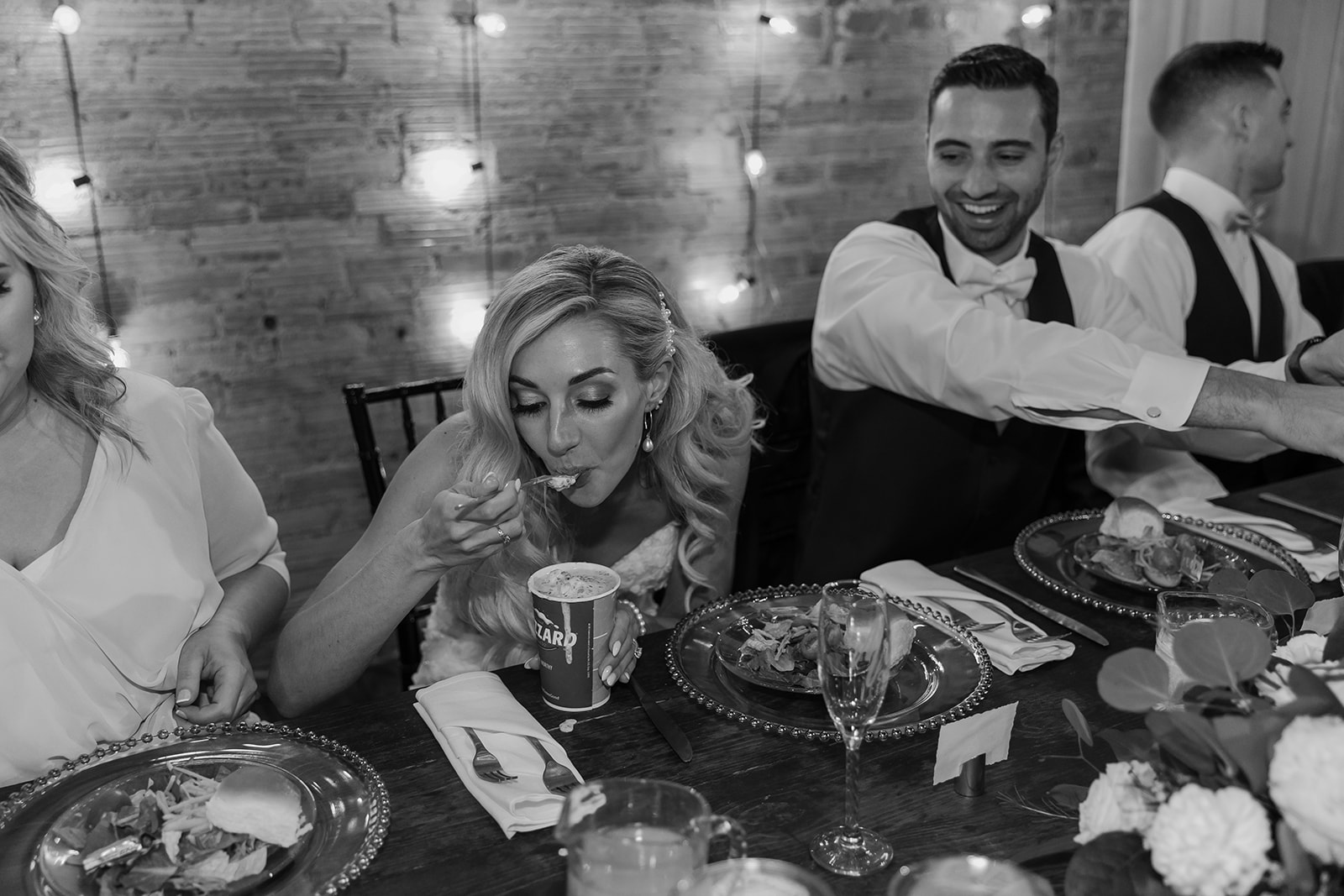 Bride and groom are surprised as they are given a Dairy Queen blizzard during their reception dinner.