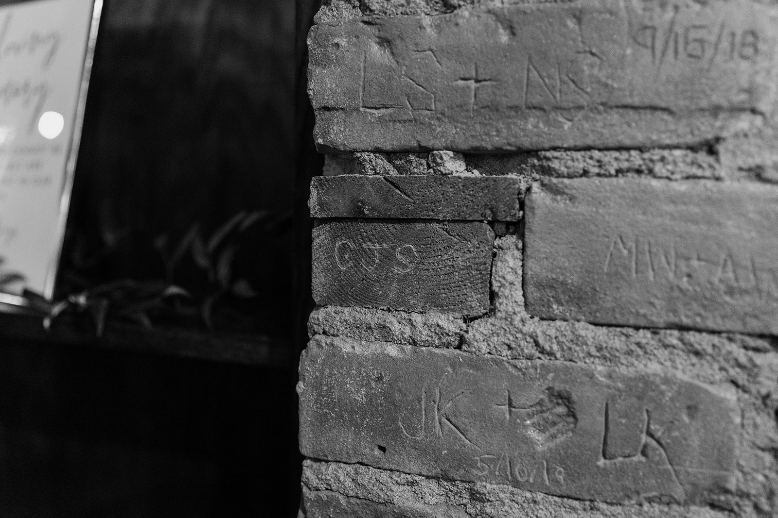 Bride and groom's initials carved into the walls of their wedding venue.