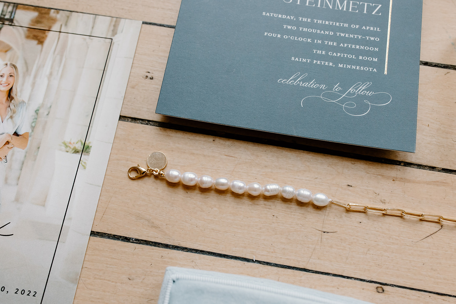 A close up of the bride's bracelet as it lays amongst her other wedding day details.