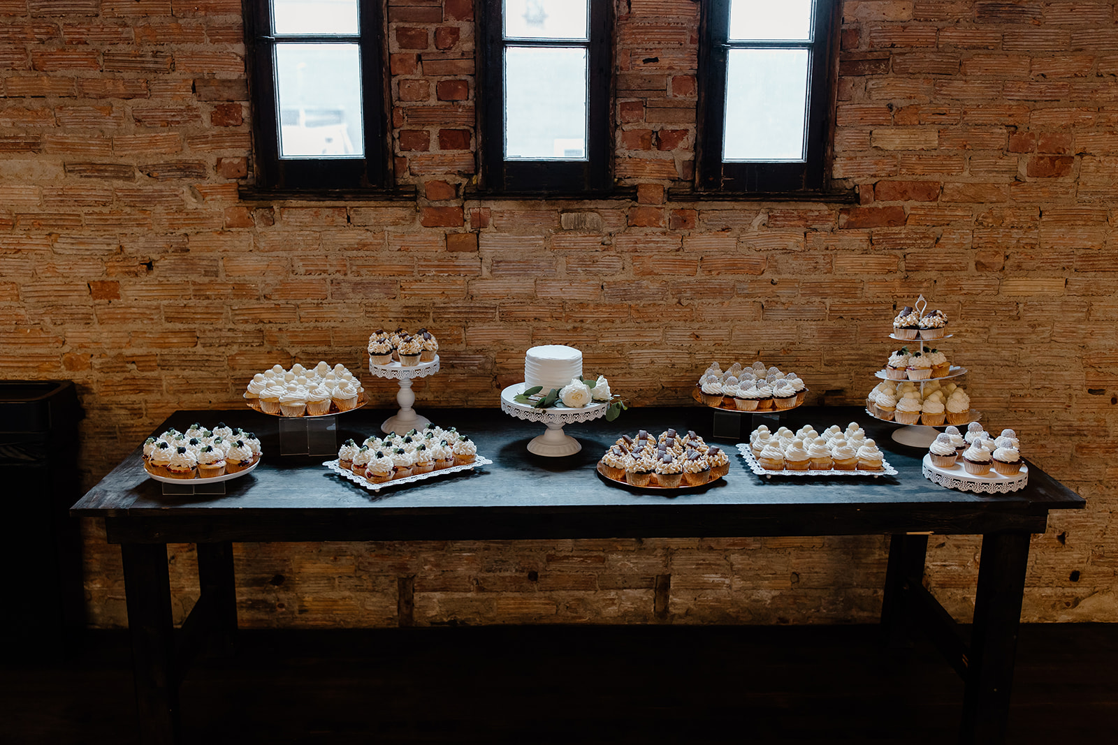 Dessert table full of cake, cupcakes, and other delicious treats. 