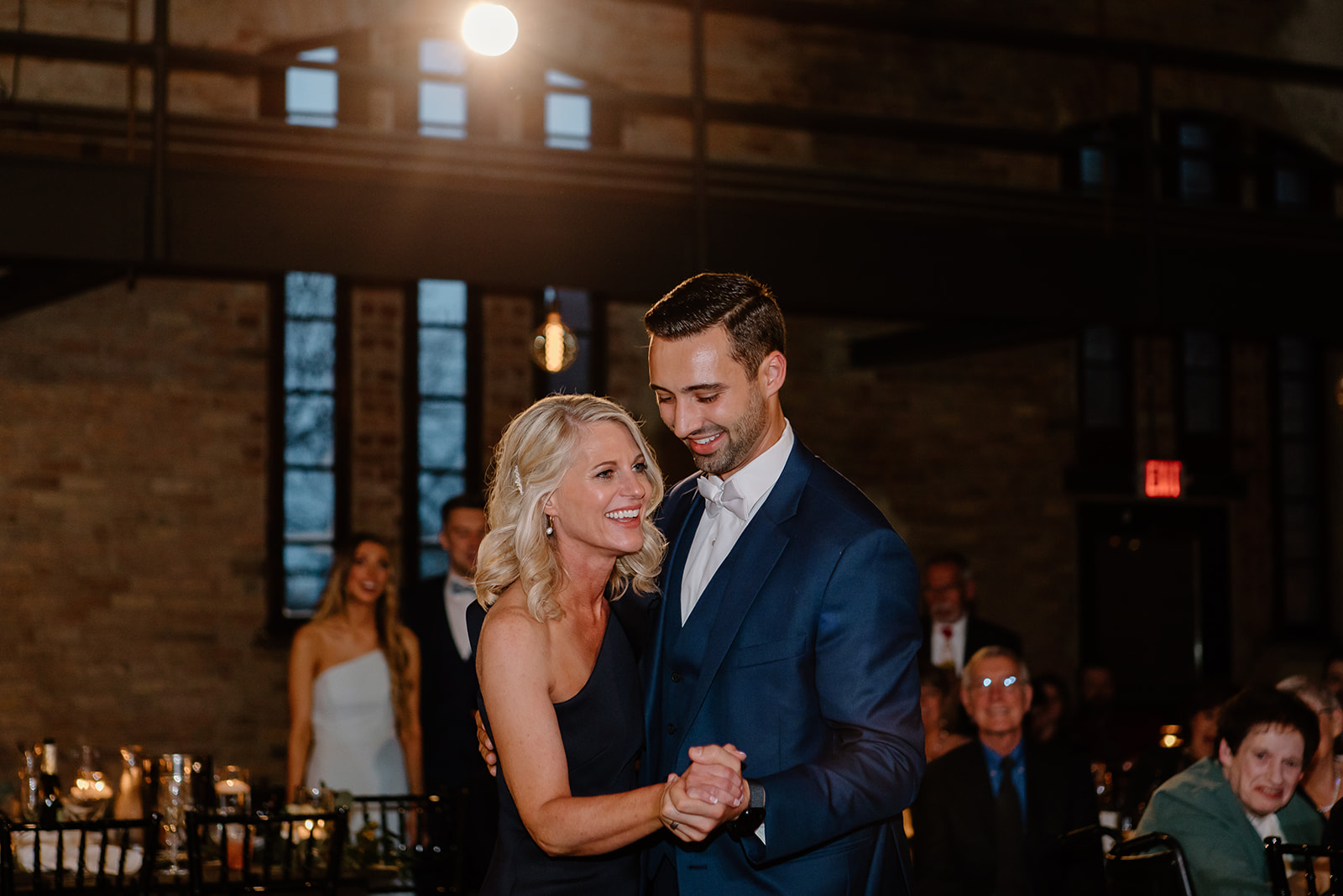 Mother of the bride dances with her new son in law.