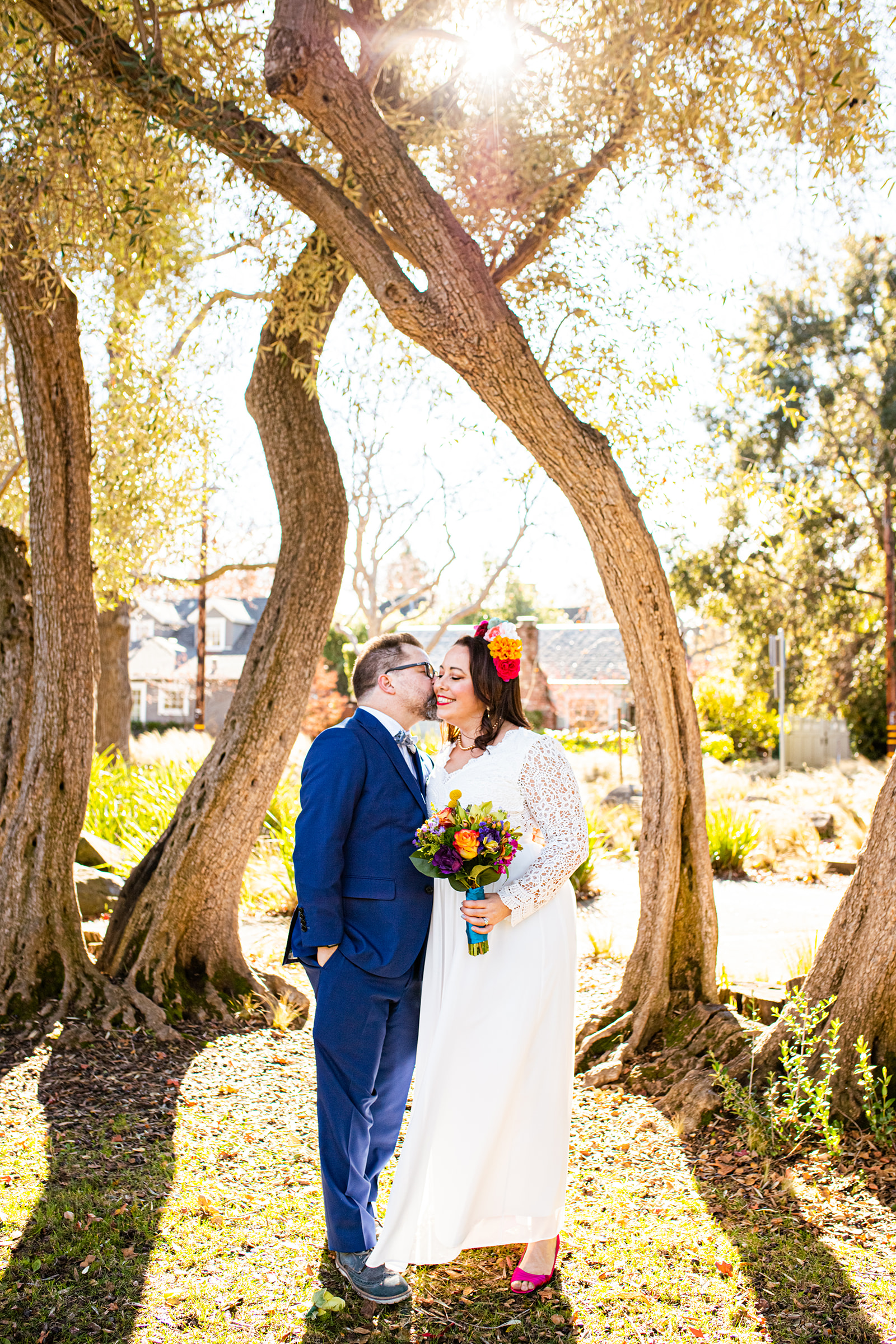 bride and groom colorful kiss park wedding