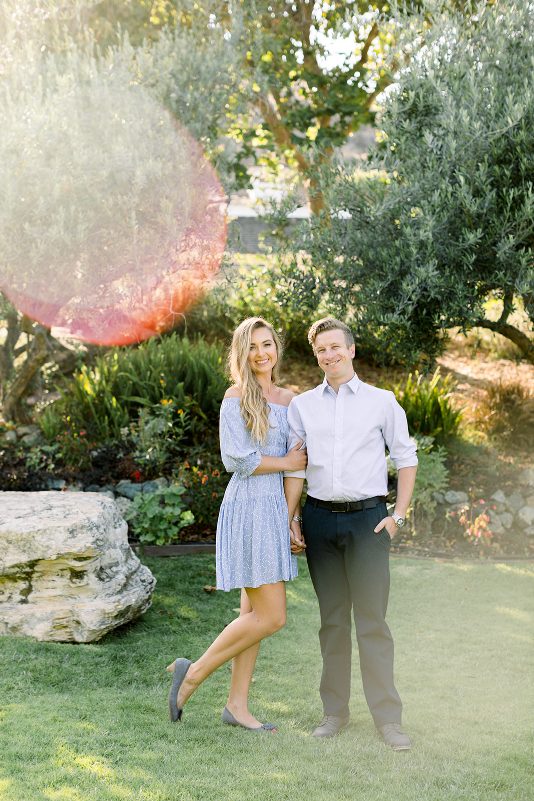 Secret Garden engagement session at the Madonna Inn with sunflares