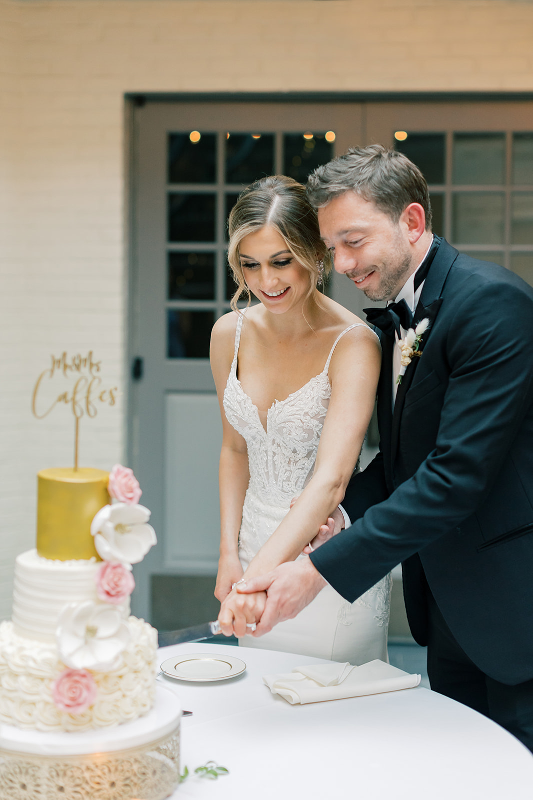 Bride and groom cut their wedding cake. 