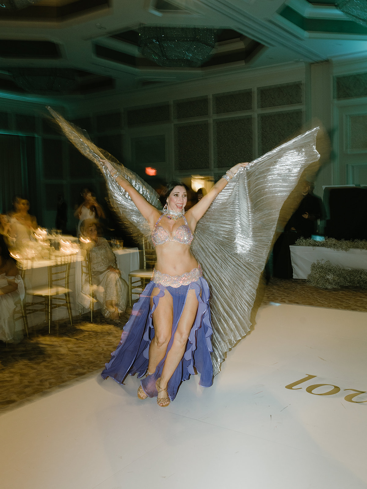 Traditional belly dancers at this luxury wedding reception at the Four Seasons Orlando Resort