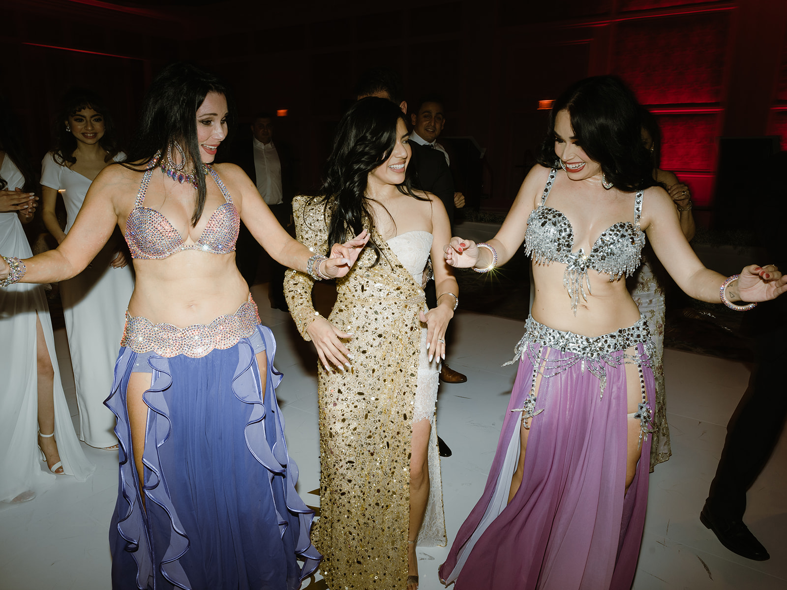 The bride with the belly dancers at her luxury wedding reception