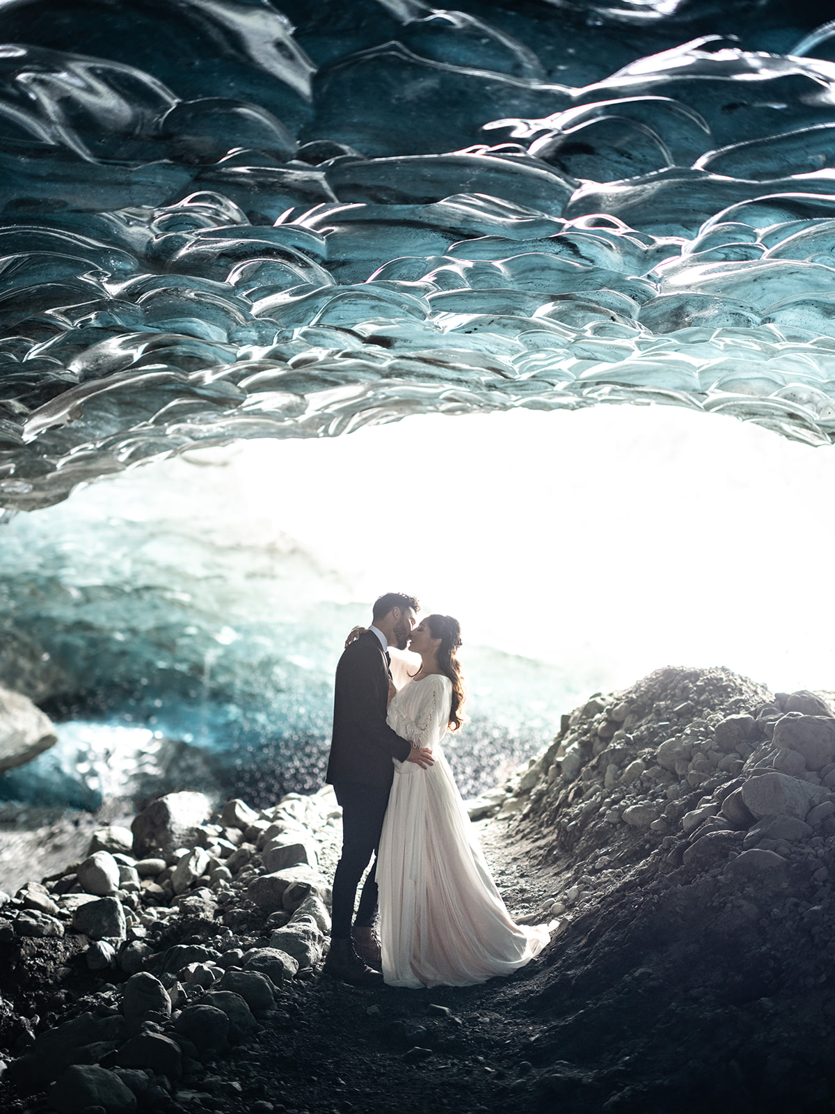 bride and groom kissing in an Iceland Ice Cave.