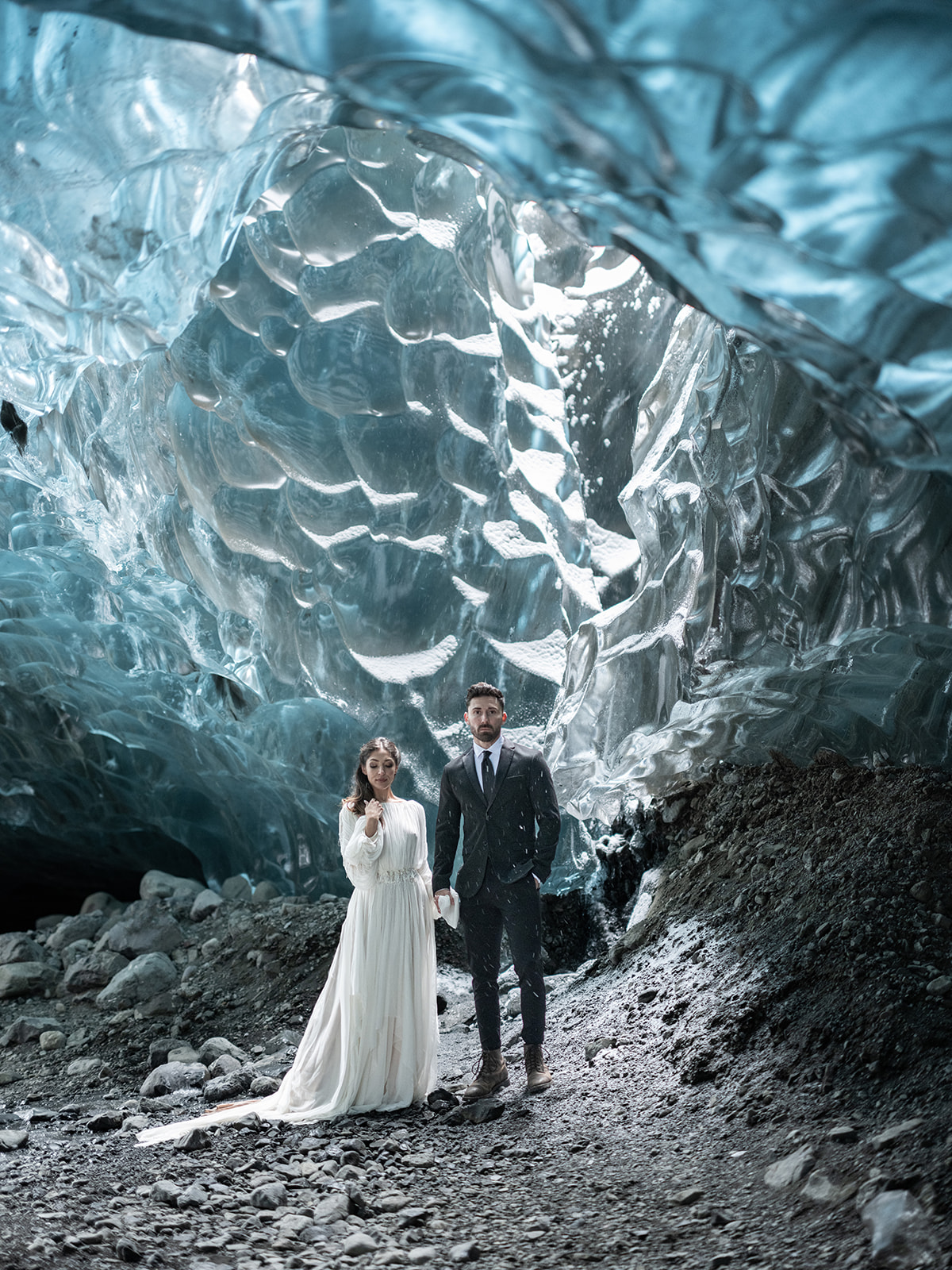 Bride and groom exploring and Ice Cave during their Iceland Elopement.