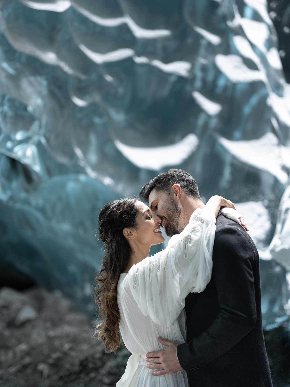 bride and groom sharing an intimate moment in an ice cave during their elopement in Iceland