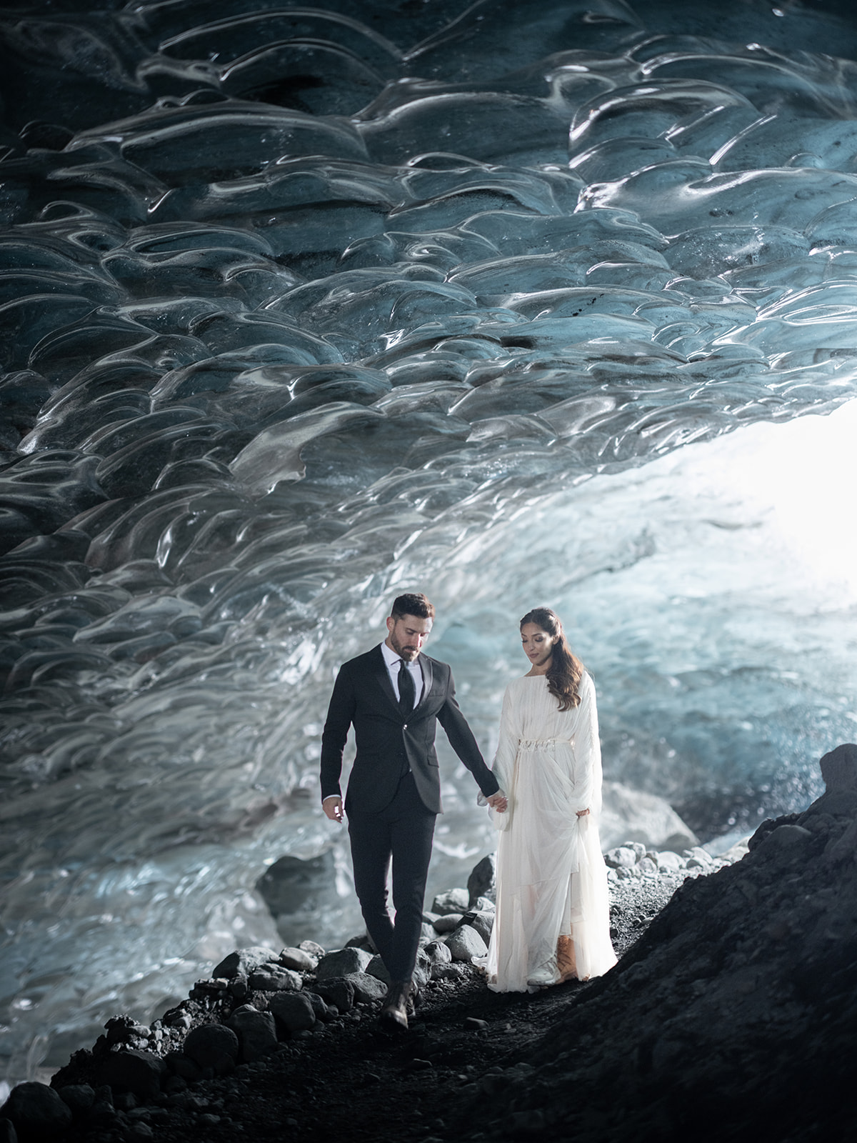bride and groom exploring and ice cave during their Iceland Elopement 