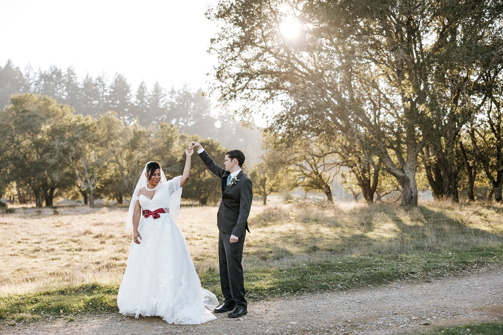 Bride and Groom dancing outside during golden hour