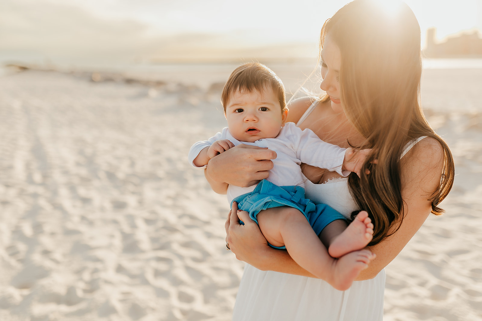 Beach Family Photoshoot in Orange Beach - mother holding infant