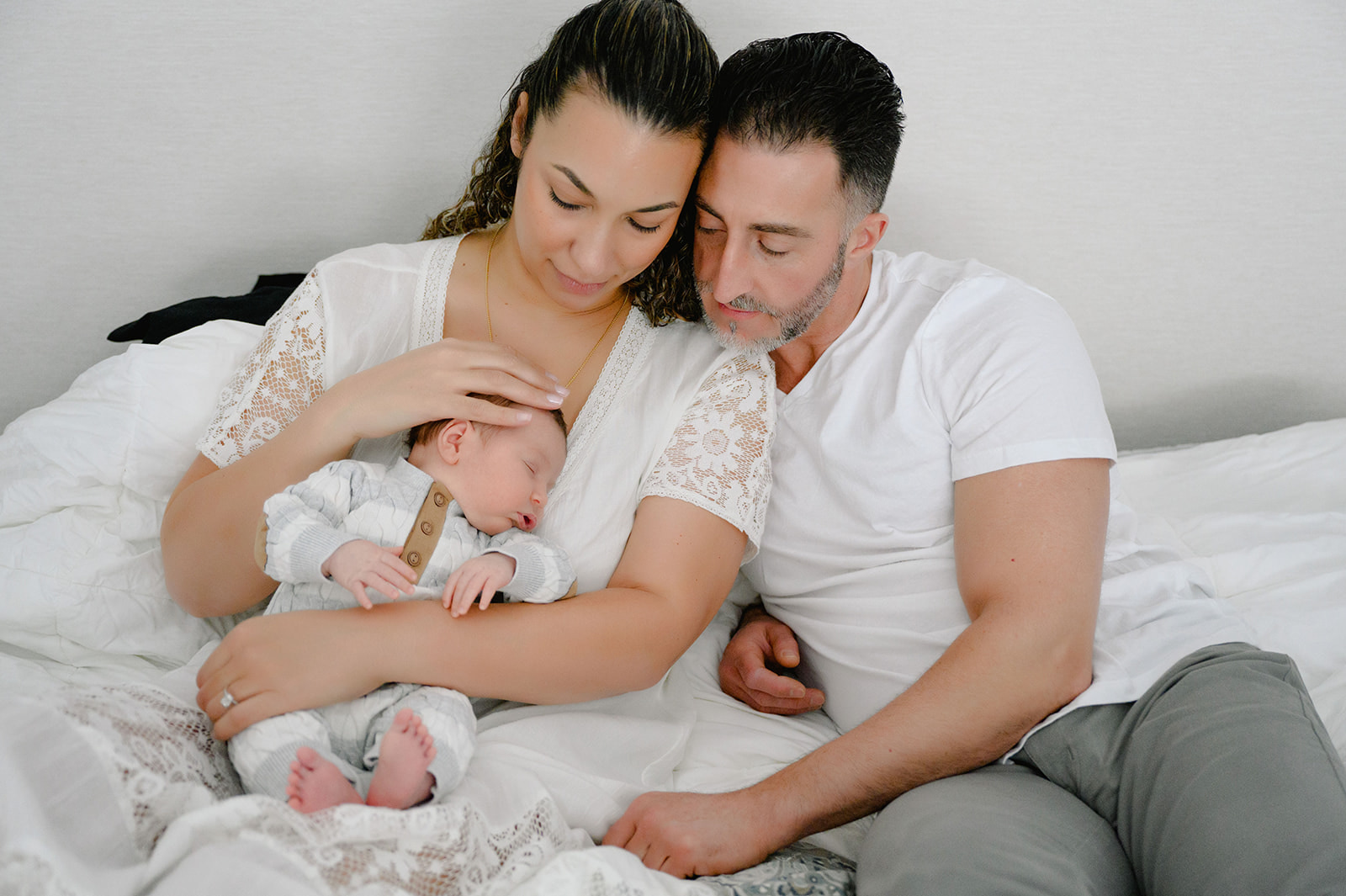 Loving parents holding their newborn's tiny hand in a close-up shot