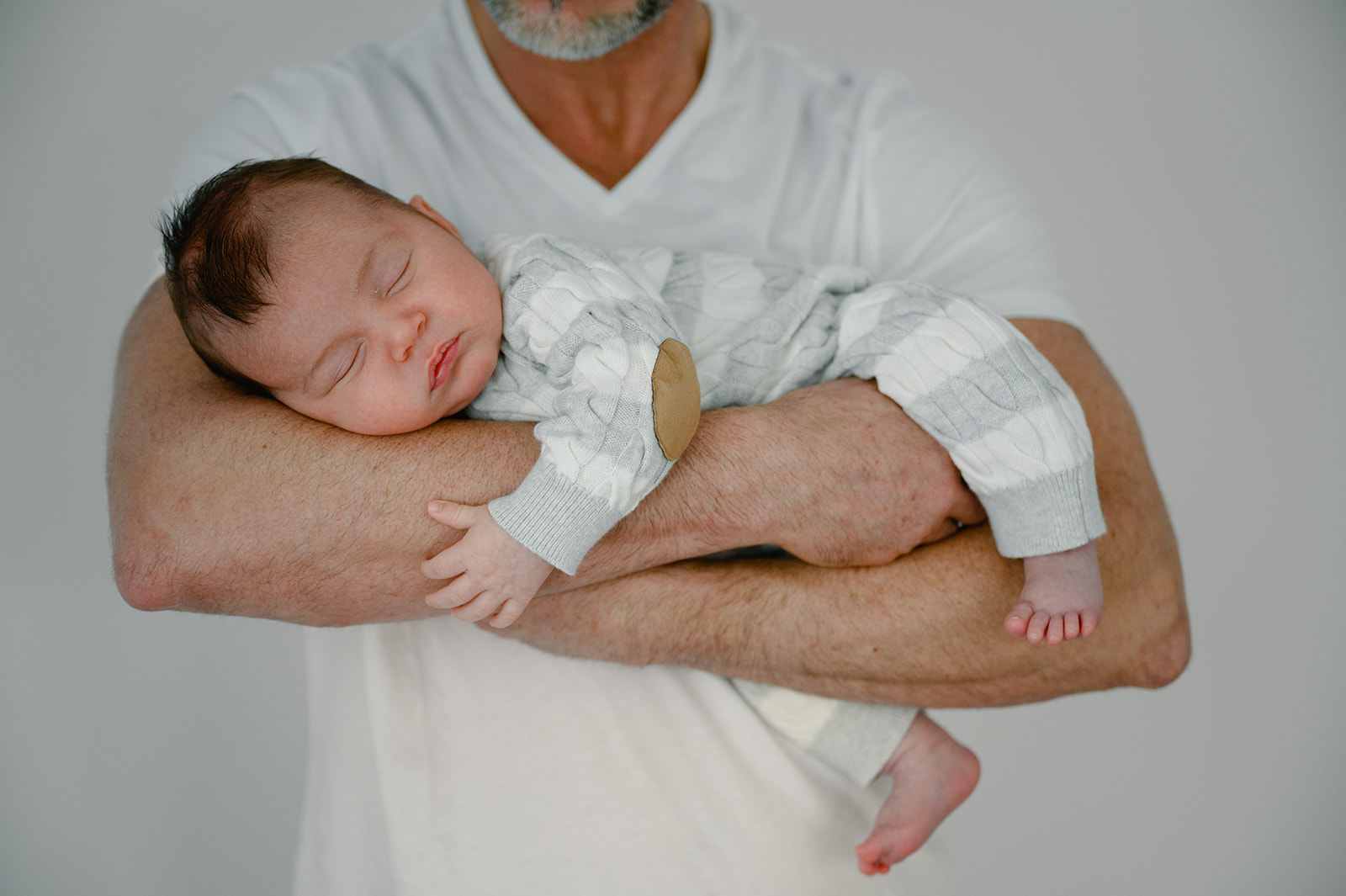 photo of dad holding his newborn baby 