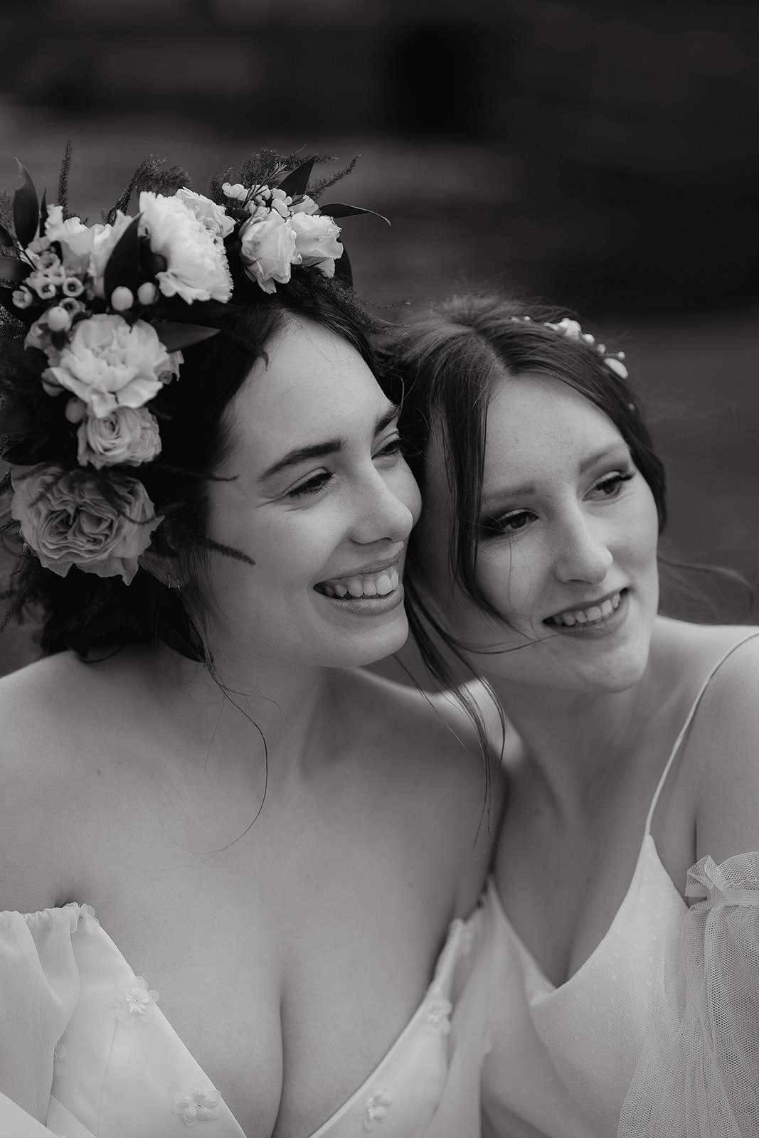Black and white photo of two brides looking into the distance together