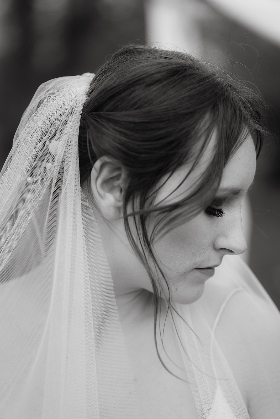 Black and white portrait of a bride wearing a veil and soft updo at Mapledurham House wedding venue