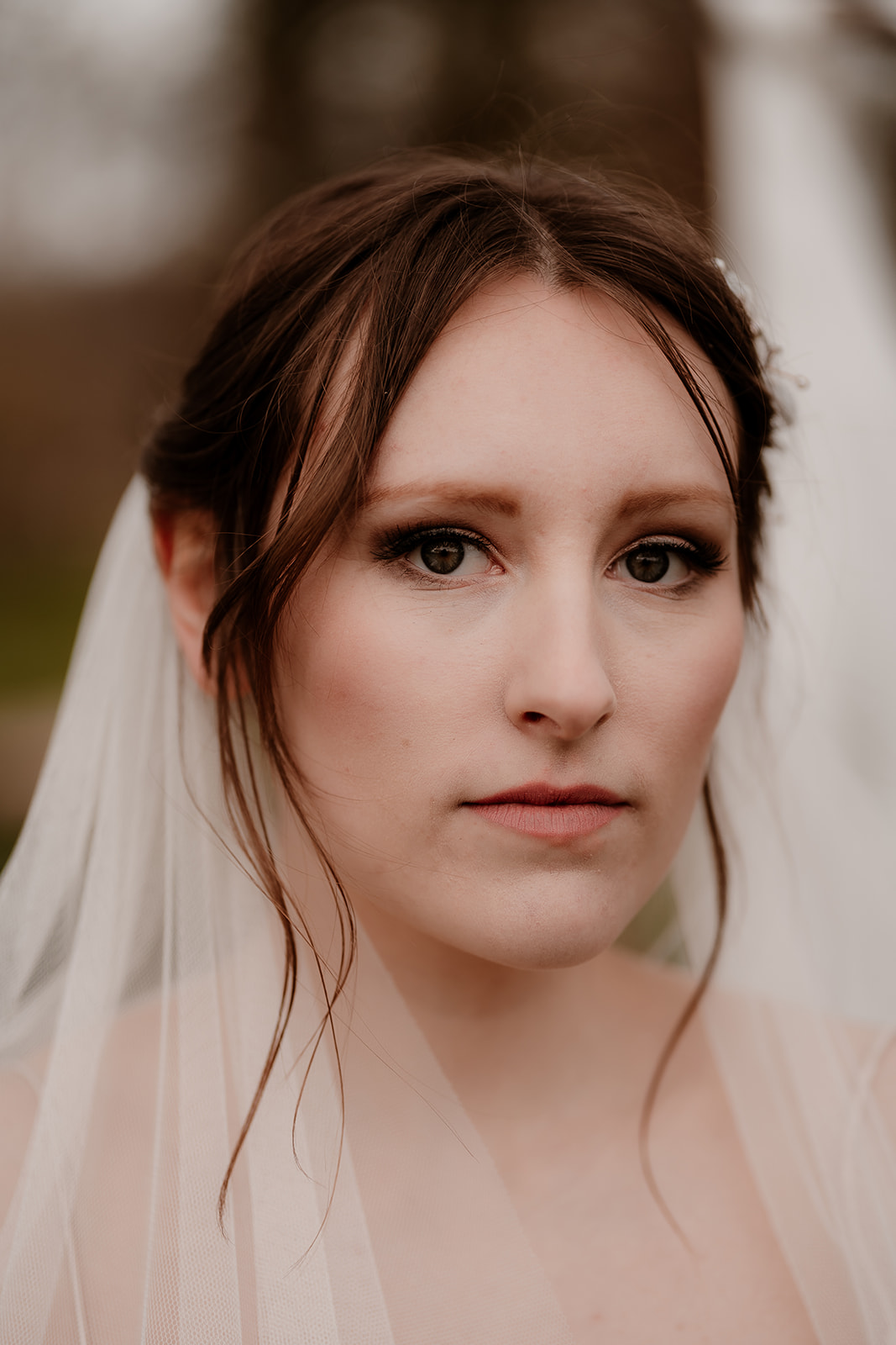 portrait of a bride wearing a veil and soft updo at Mapledurham House wedding venue
