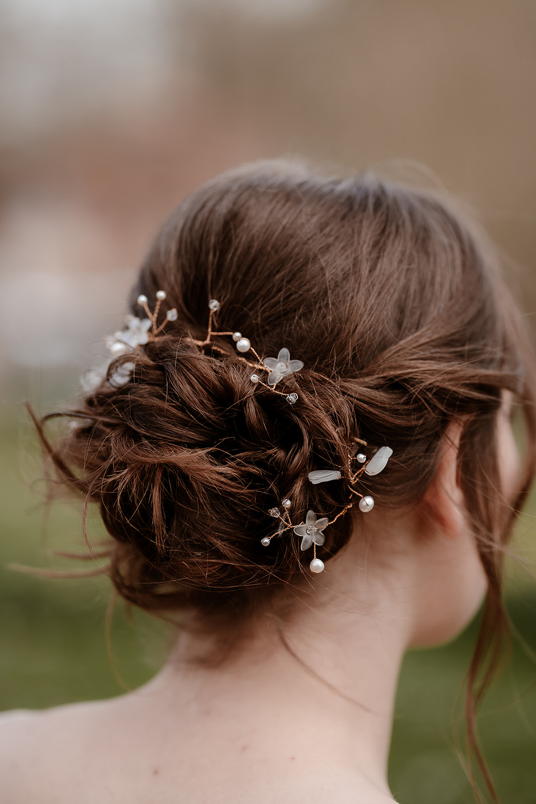 portrait of a bride wearing soft bun updo and delicate hair vine at Mapledurham House wedding venue