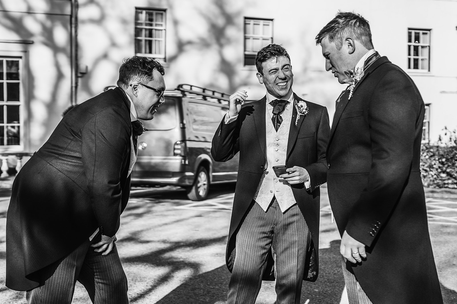 A groom and his groomsmen laughing