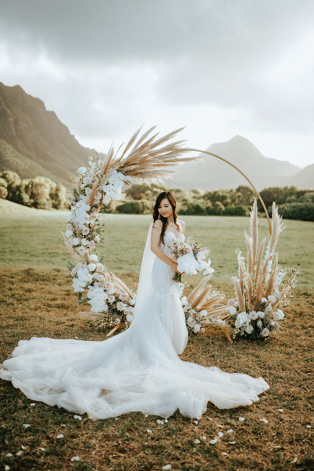 Bride in front of her elegant arbor in Kualoa Ranch Hawaii
