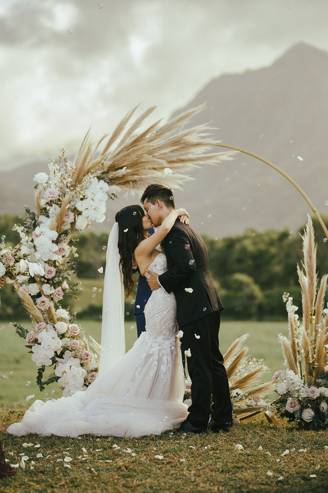 Bride and groom kiss at Wedding ceremony in Kualoa Ranch Hawaii