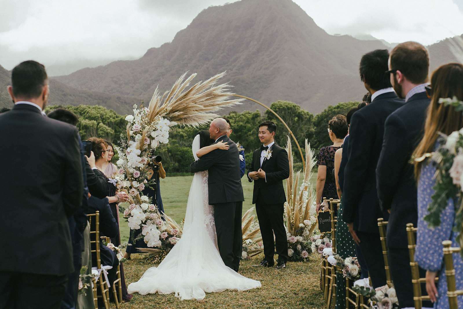 Bride Hugs Father at Wedding ceremony in Kualoa Ranch Hawaii