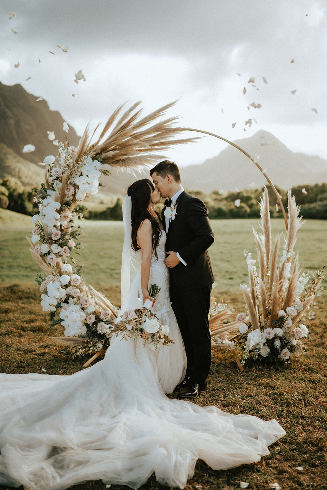 A couple that just got hitched in front of their arbor in Kualoa Ranch