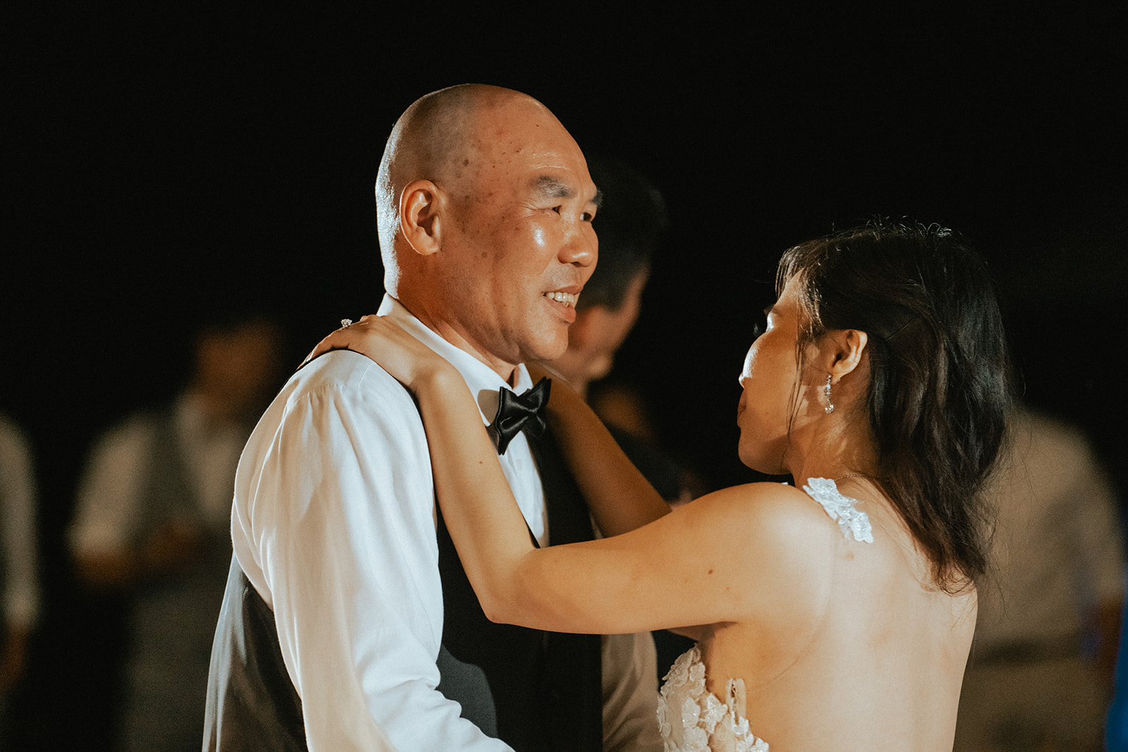 Father daughter mother son dance at an outdoor wedding reception at Kualoa Ranch