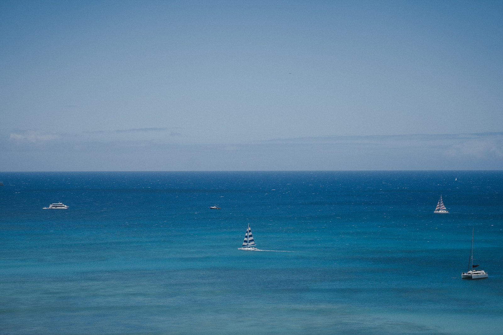 Sail boat in a sea of blue