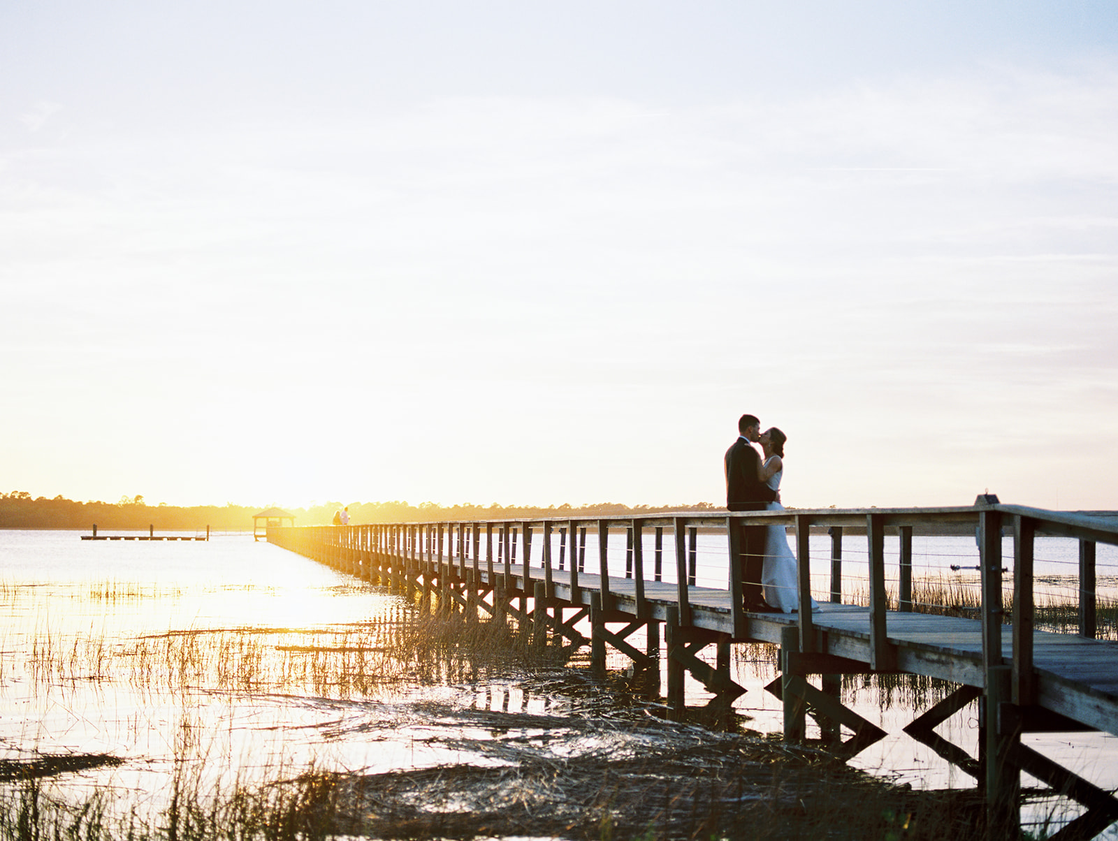 bride and groom on dock at lowndes grove in charleston