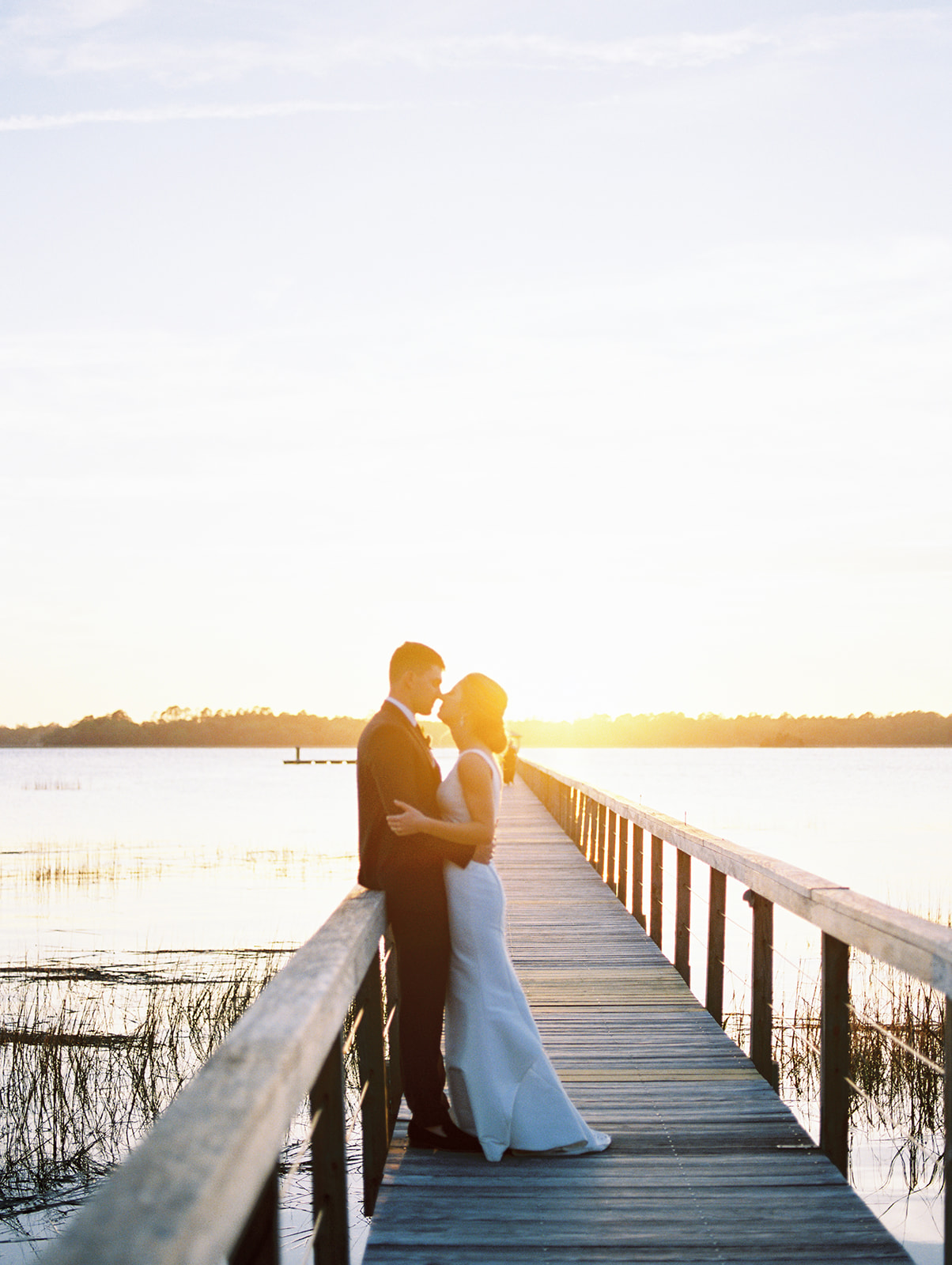 bride and groom on dock at lowndes grove in charleston