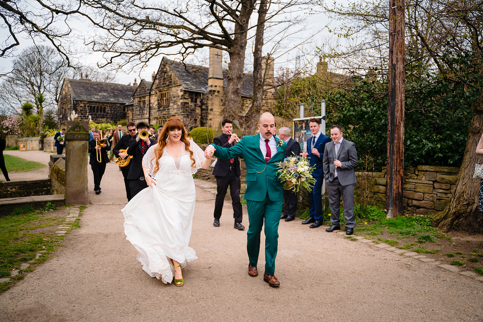 bride and groom dance on way inside Oakwell Hall barn