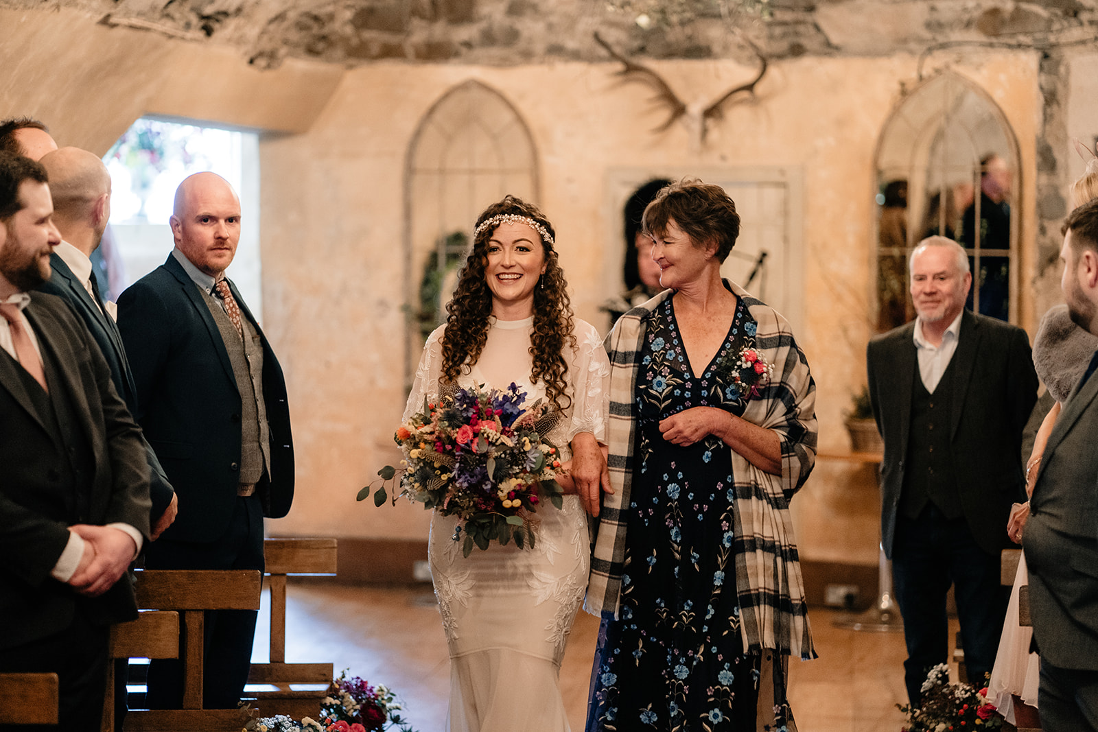 A bride making her entrance to the wedding ceremony at Neidpath castle.