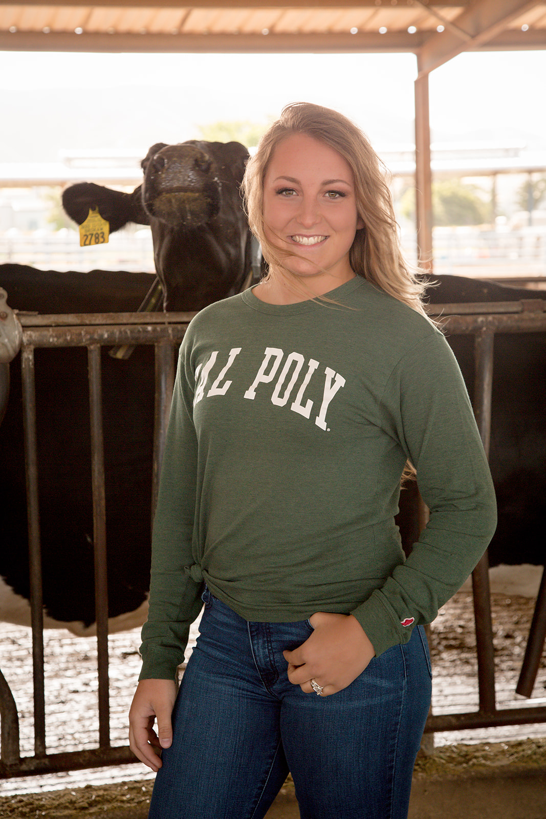 Dairy Science senior took cal poly senior photos for graduation at the dairy ranch