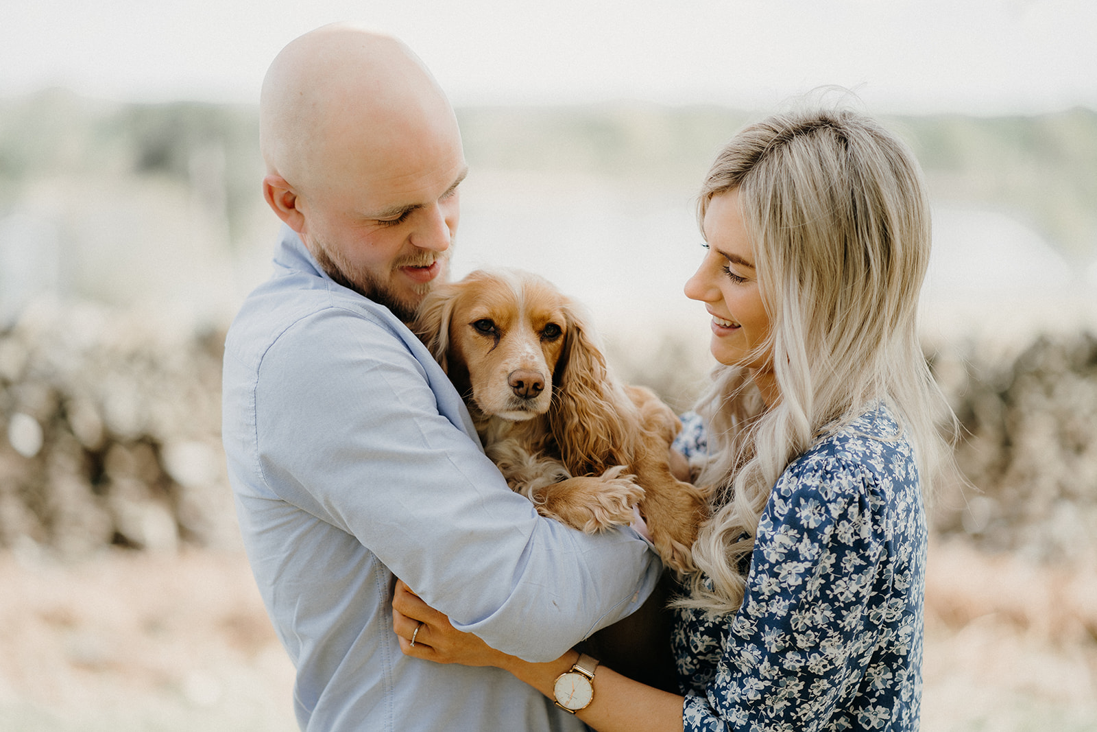 Couple with their cocker spaniel dog, having a cuddle.
